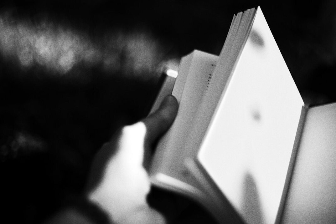 Hand writing in a notebook with a pen